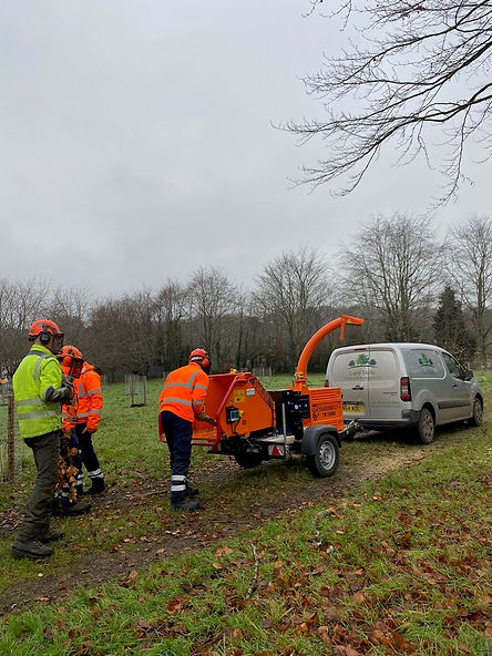 Men on training course using a woodchipper.