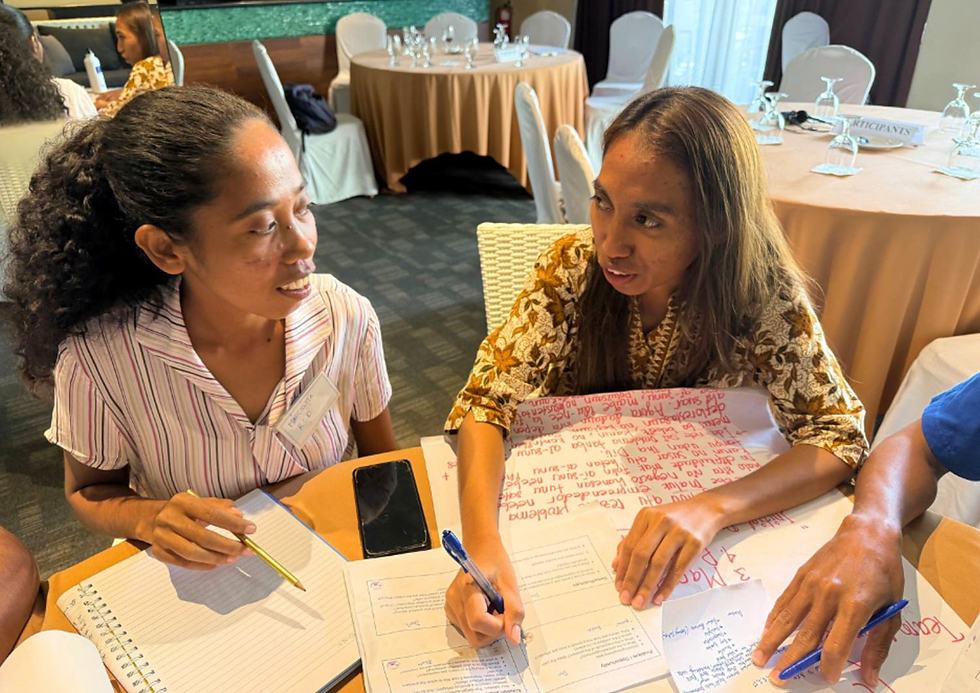Palensia da Costa Silva and her teammates engage in a focused group discussion on project design and development during the YECAP Bootcamp, collaborating on innovative renewable energy solutions for their communities.