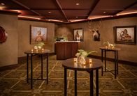 Hotel reception area featuring custom wood counters, display tables, and decorative wall paneling.