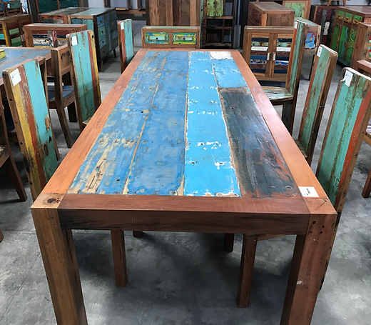 Custom reclaimed wood dining table constructed from salvaged timber planks, featuring original painted surfaces, solid wood frame, and handcrafted construction.