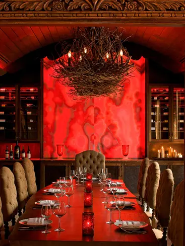 Custom hand-carved wood dining room entrance with carved teak panels leading into a private restaurant conference room.