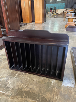 Dark-finished wooden storage cabinet with vertical dividers and a cushioned top.