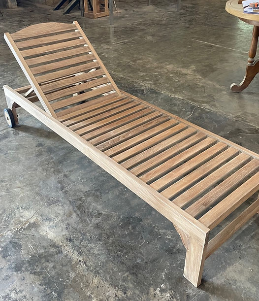 A-grade teak chaise lounge being manufactured in an Indonesian furniture factory, showing unfinished teak wood, slatted construction, and export-grade outdoor furniture production.