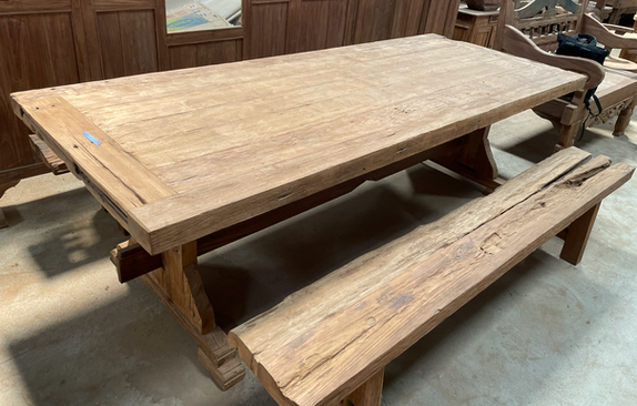 Large reclaimed teak dining table with matching recycled teak bench seating.