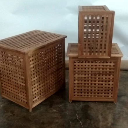 Three solid wood storage cabinets featuring geometric open-lattice panels, displayed in different sizes.
