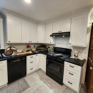 White shaker kitchen with subway tile backsplash and black countertops in Seacoast NH