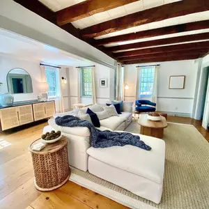 Bright living room with wooden beams and modern decor.