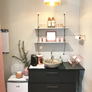 Cozy kitchenette with shelves, sink, and mini fridge.