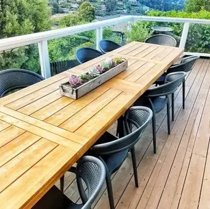 Outdoor dining area with wooden table and chairs.