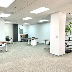 Spacious office with desks and modern decor.