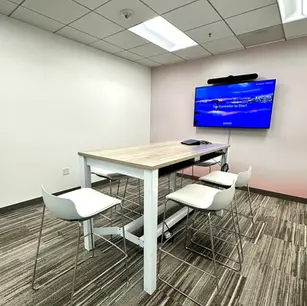 Modern meeting room with high table and chairs.