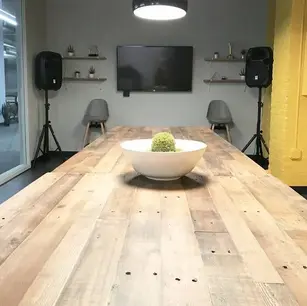 Modern conference room with wooden table and decor.