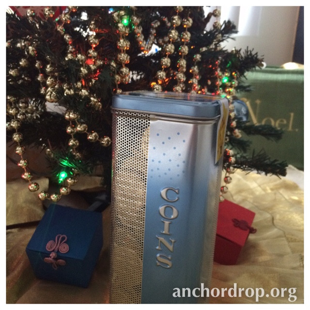 Coin tin under a christmas tree
