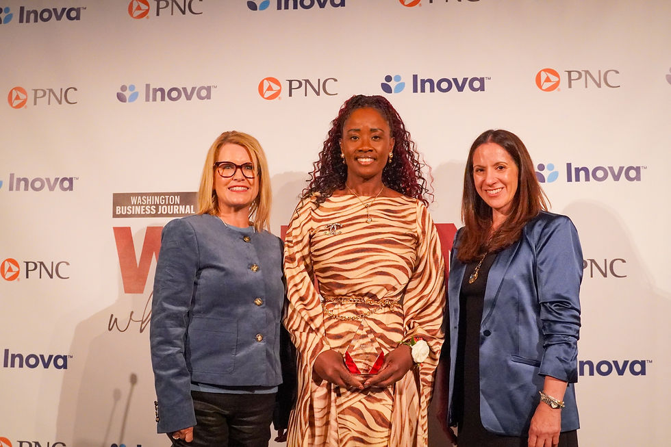 Isabella Piña holding her 2026 Women Who Mean Business award with two attendees at the Washington Business Journal celebration.