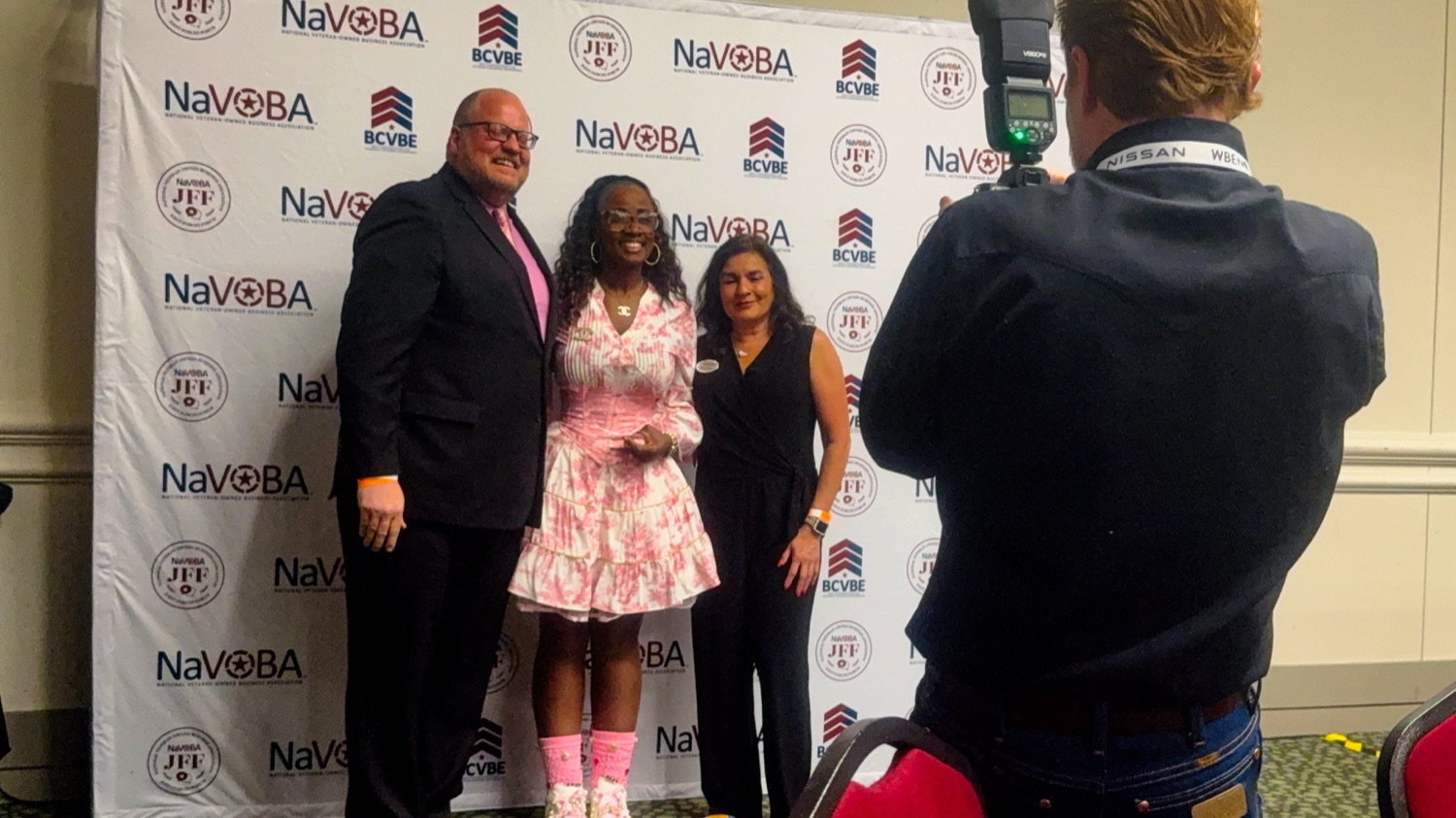Isabella Pina at the NaVOBA awards backdrop for the 2026 Women's Veteran's Business Enterprise of the Year ceremony
