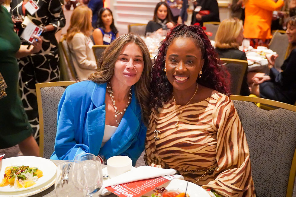 Isabella Piña and another attendee smiling at a dinner table during the Washington Business Journal awards celebration.