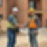 2 people at the work site shaking hands one is the client the other one is the tradie.jpg