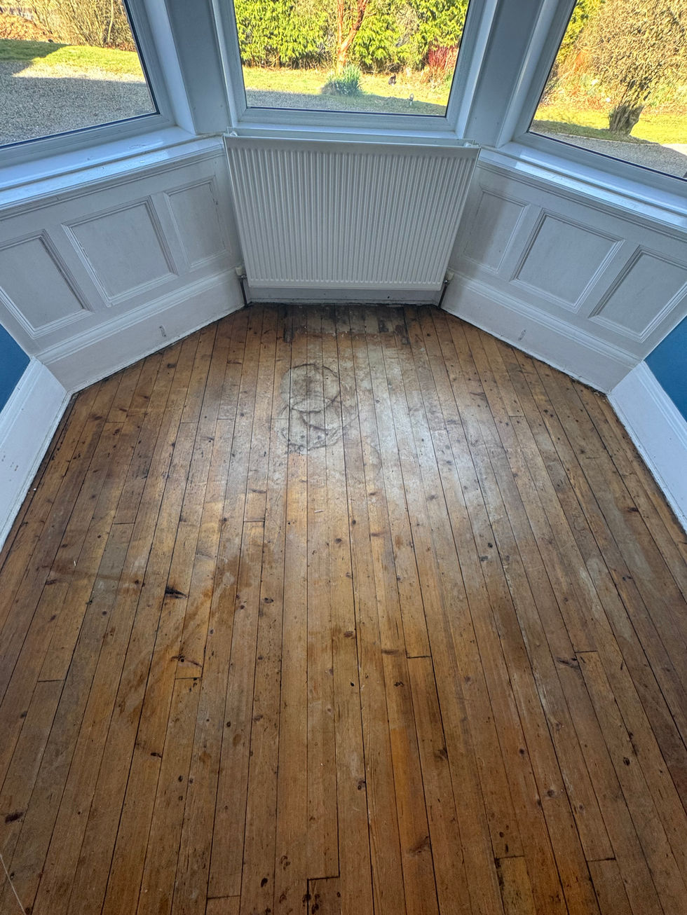 Original solid wood flooring in a dining room in Crawford. Prior to being sanded