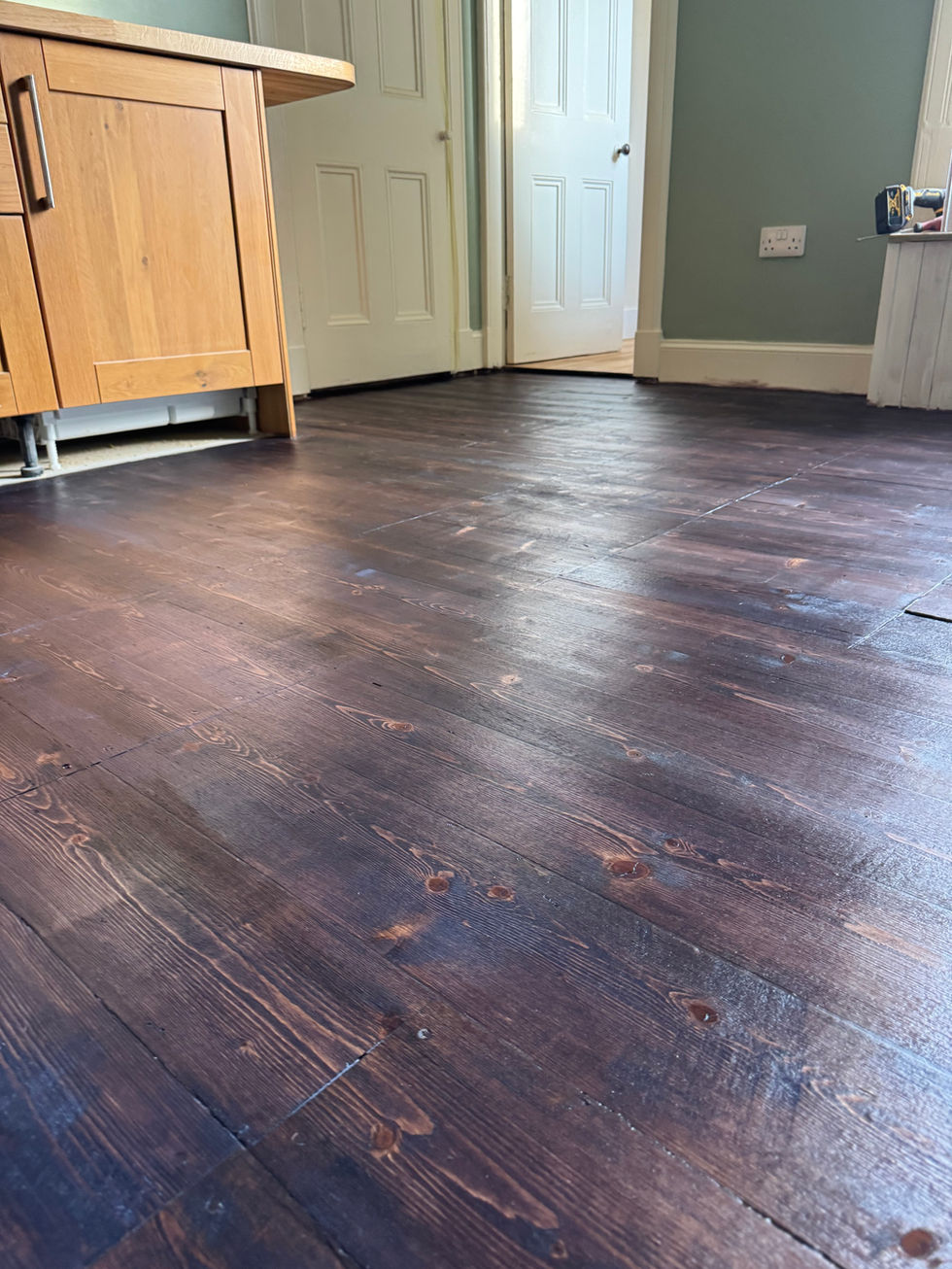Original tenement solid wood flooring in a kitchen in Edinburgh. Stained with a walnut stain and vanished