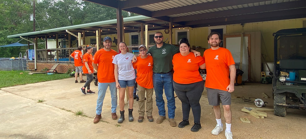 Heart & Hammer TX volunteers standing in front of a house