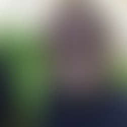 Amy wearing sunglasses smiling in front of her aquaponics farm