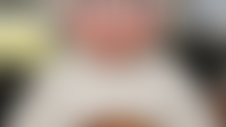 a grandma in a kitchen in front of a turkey with an open-mouthed, shocked look on her face