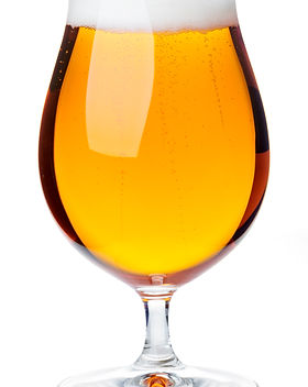 Full beer snifter glass of pale lager of