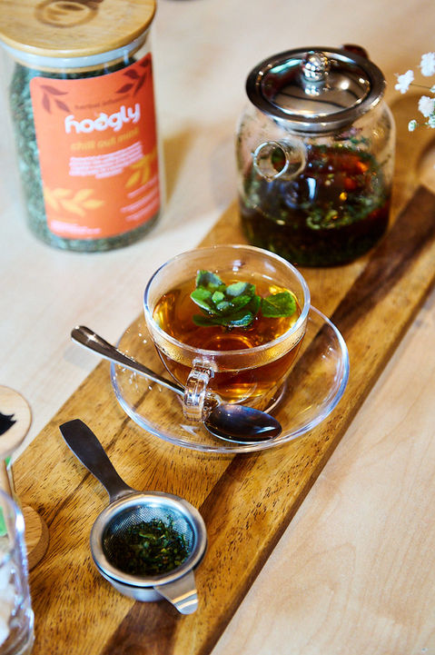 Brightly lit dining table with assortment of tea paraphernalia