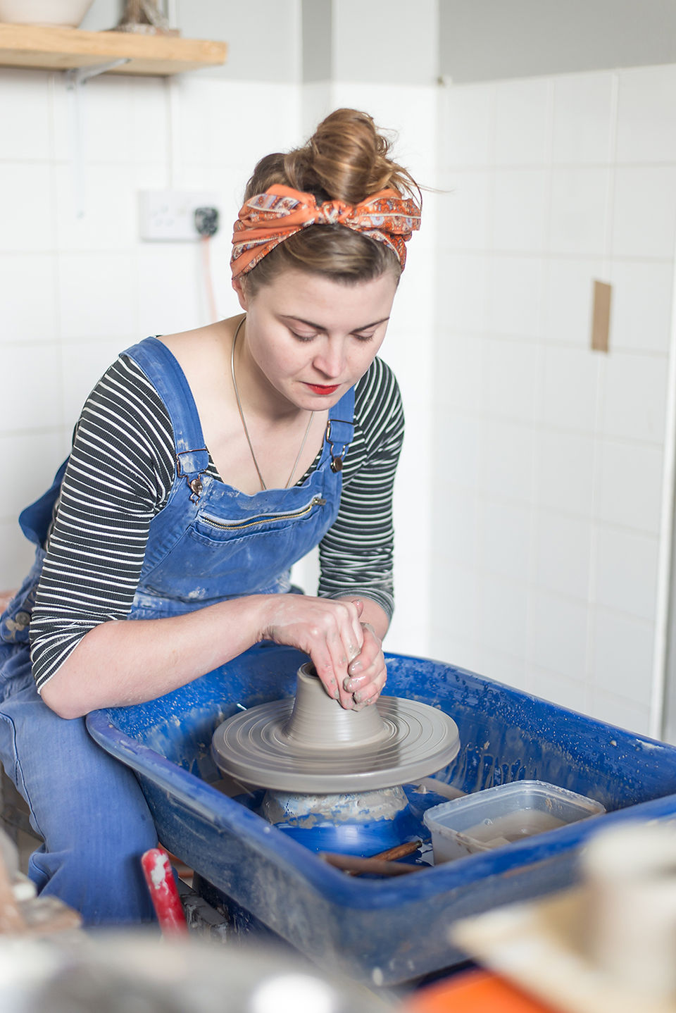 Brand Storytelling Photography for a ceramicist capturing her throwing on the potters wheel.