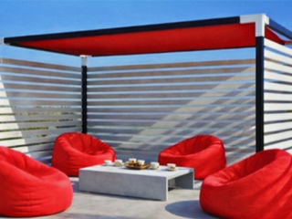 Luxury pergola over patio with red beanbag chairs