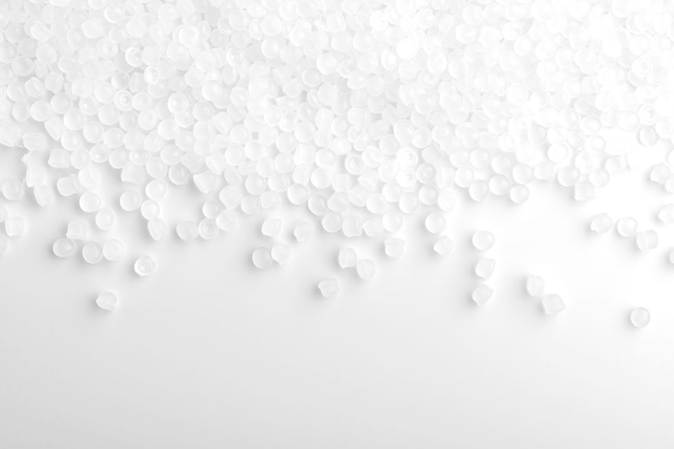 translucent-polymer-pellets-scatter-across-white-s-2026-03-11-18-19-38-utc.jpg