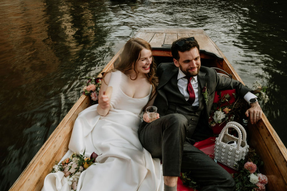 Bride and groom punting on river Cam Cambridge wedding photography