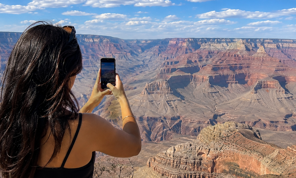 Woman taking photo of grand canyon.png