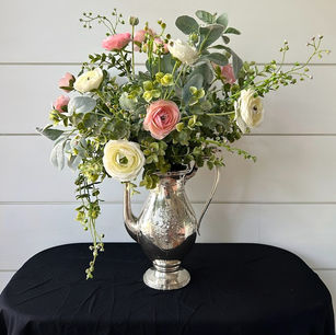 silver teapot filled with flowers