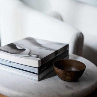 A still life interior moment with books and vessel