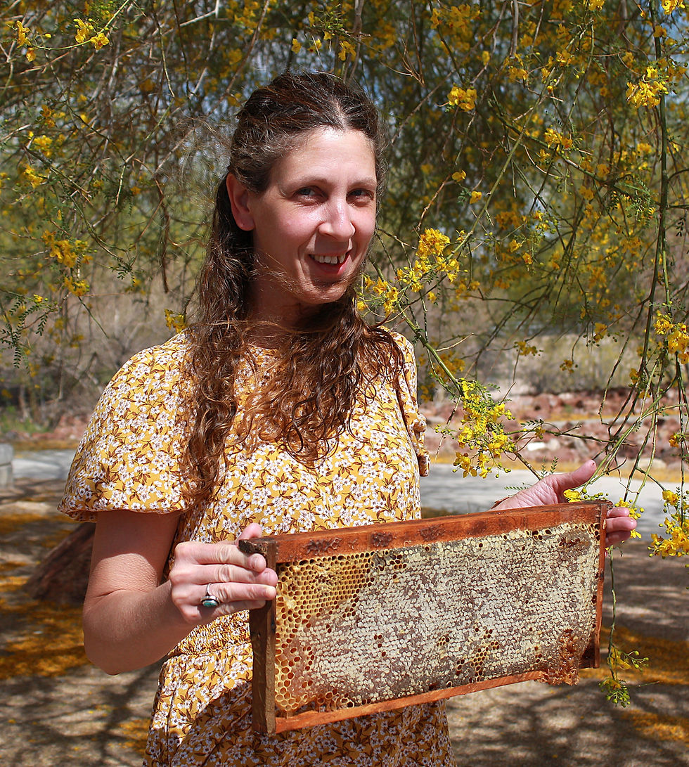 Betsy enjoys showing off a honeycomb frame bursting with honey.