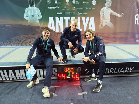 British Team Makes History with First-Ever Gold at 2025 Junior European Championships - two fencers from Knightsbridge Fencing - Alec and Cador with Tamas coaching