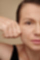 Face of mature woman pulling back skin of her face to get rid of wrinkles.jpg