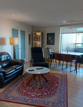 "Luxury furnished living room with high-end furniture in The Doyle, downtown Halifax"
"Spacious one-bedroom suite with ceiling to floor windows at The Doyle, Halifax"
"Den converted into a private bedroom with en-suite bathroom in The Doyle, Halifax"
"View of Halifax Harbor from the 7th floor balcony of The Doyle"
"Modern kitchen with high-end appliances and furnishings in The Doyle apartment"
"Master bedroom with well-organized walk-in closet in The Doyle, Halifax"
"Common rooftop patio with stunning views accessible to residents of The Doyle"
"High-end furnished living area with Yamaha piano in The Doyle, downtown Halifax"
"Scenic view of the South end of Halifax from The Doyle apartment"
"Convenient location of The Doyle near Halifax Public Library and Citadel"
"Luxury bathroom with modern fixtures in The Doyle, downtown Halifax"
"Fully equipped kitchen with dishes, pots, and pans in The Doyle apartment"
"Comfortable and stylish living area in furnished unit at The Doyle, Halifax"
"Proximity to Spring Garden Road shops and Halifax Board Walk from The Doyle"
"Secure underground parking space included with The Doyle apartment rental"