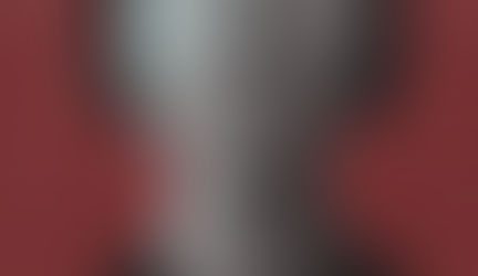 Grayscale portrait of a woman with her mouth crossed out by gray brush strokes against a red background representing being silenced.