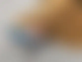 Blue high heels stick out from under a "WELCOME" doormat on a gray floor, creating a humorous, unexpected scene that represents being walked over.