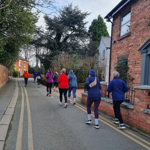 Group of people running up a hill