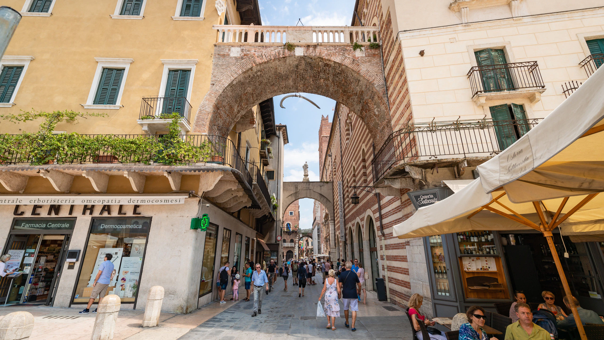 Famous street in Verona with an arch and a hanging whale rib