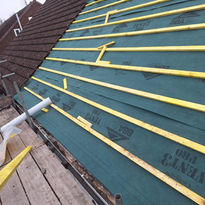 Scaffold in front of felted roof