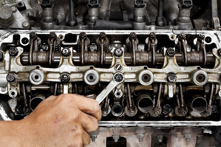 Engine being adjusted with a spanner