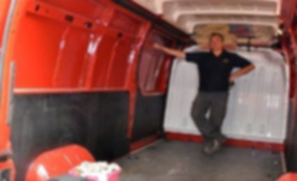 man stood in an empty red Renault van