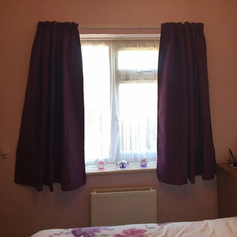 Dark curtains open on a window