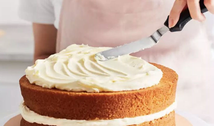 woman icing a cake