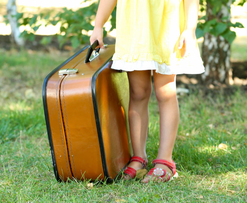 little girl with suitcase running away from home