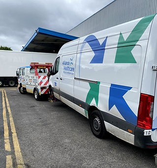 Hunter Recovery truck towing large white van